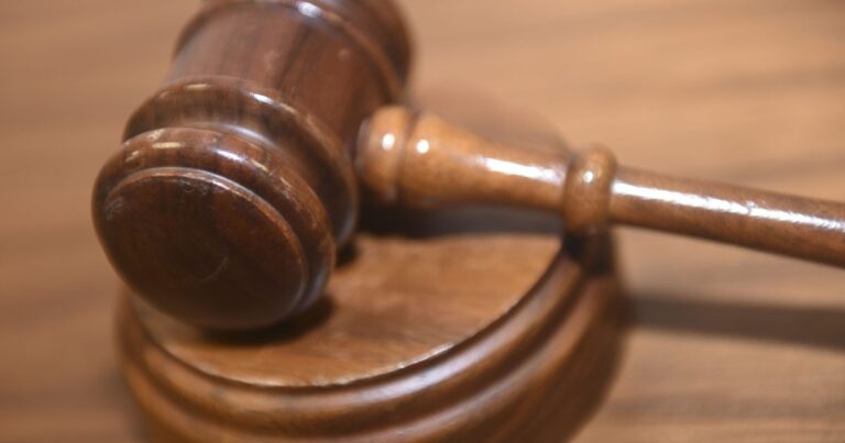 Courtroom gavel with American flag in background