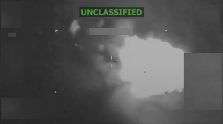 US Navy silhouette against sunset over ocean, strike operations at sea