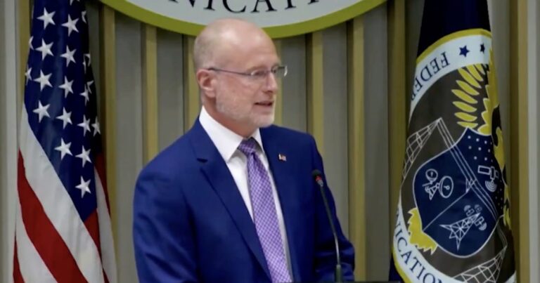 FCC Chair Brendan Carr speaking at a podium