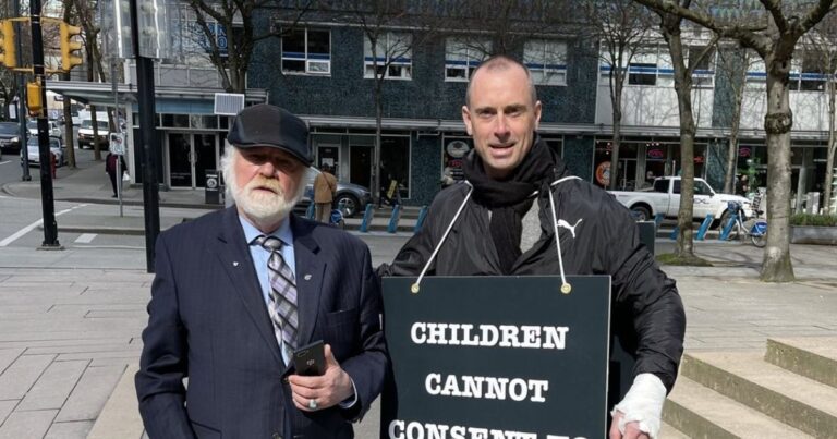 Gavel and protest sign outside school board meeting