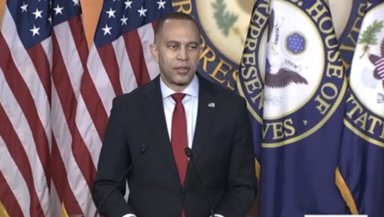 Hakeem Jeffries speaking at a podium