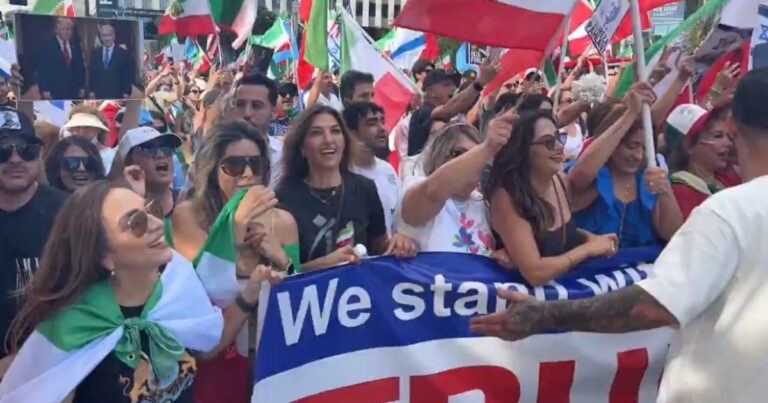 Crowd on Wilshire Boulevard waving American and Israeli flags