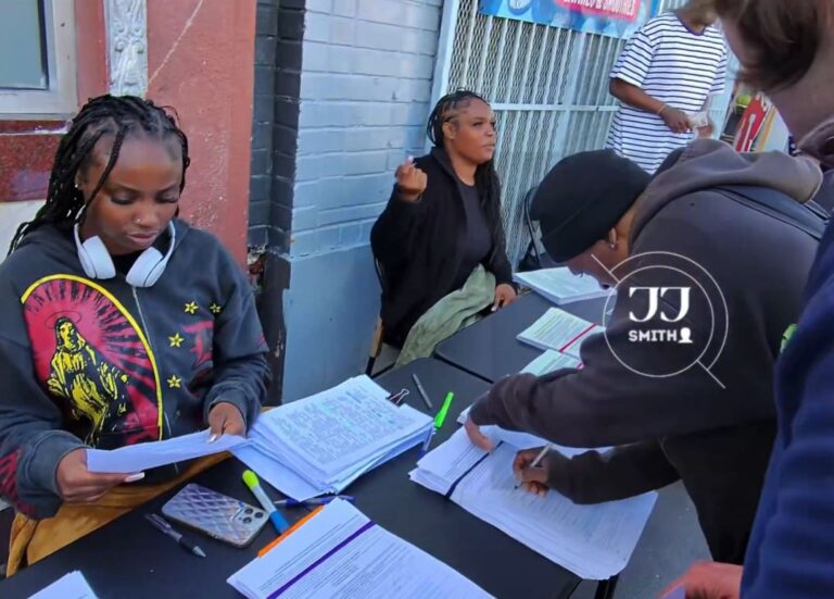 People lining up to sign petitions on a street corner in San Francisco