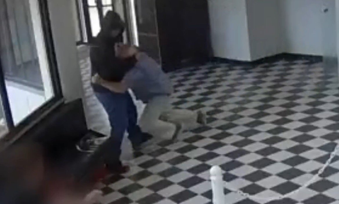 Surveillance video still of an Oklahoma principal confronting an armed former student