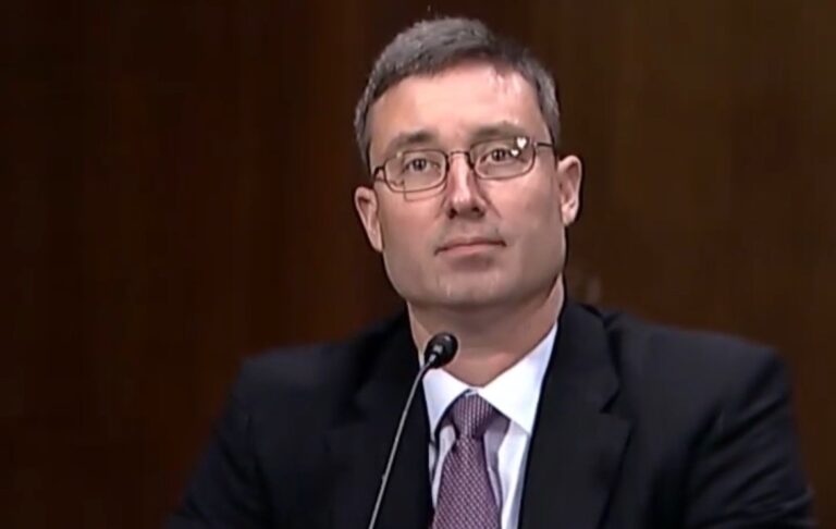 Federal judge gavel with immigration paperwork on a desk