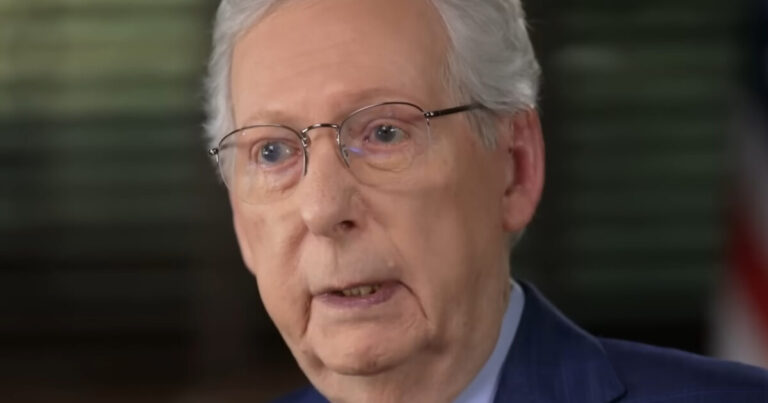 Senator Mitch McConnell seated in a rehab bed beside Elaine Chao