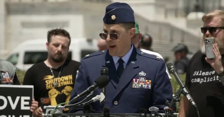 Air Force Major Jason Watson in uniform at a Capitol protest before his arrest